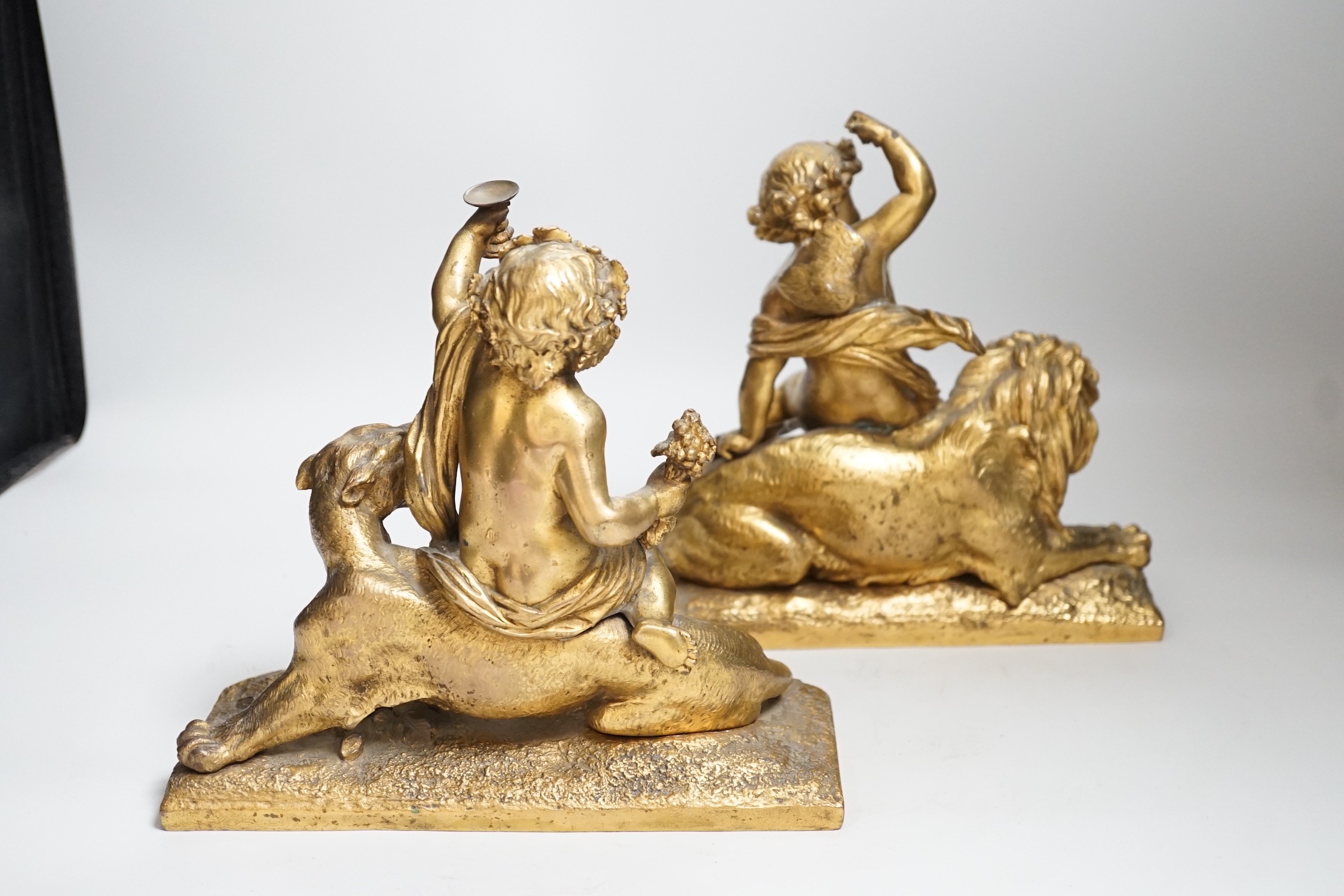 A pair of 19th century gilt metal cherub groups, 20cm tall